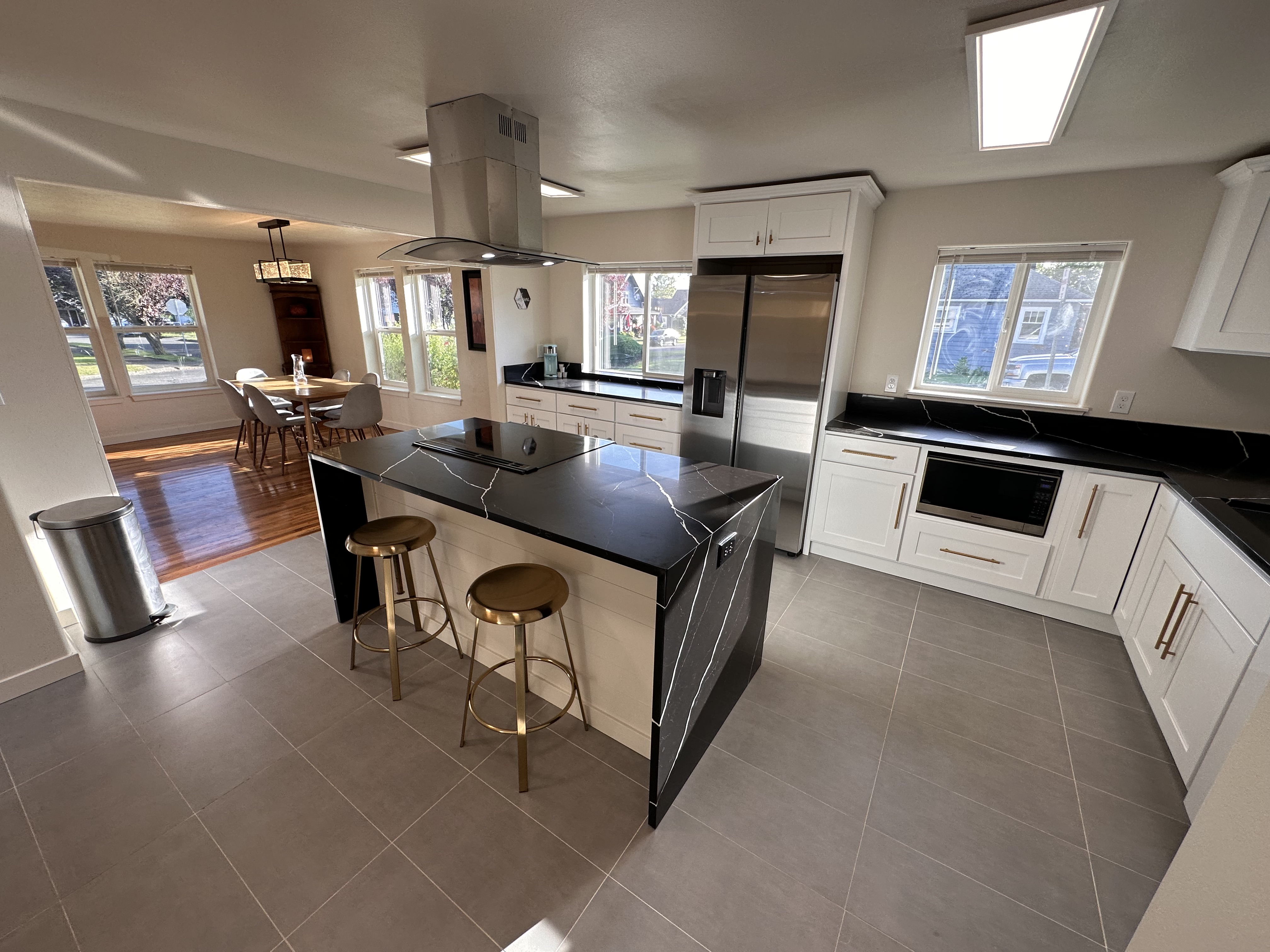 The Alfred updated kitchen with black counters and central island.