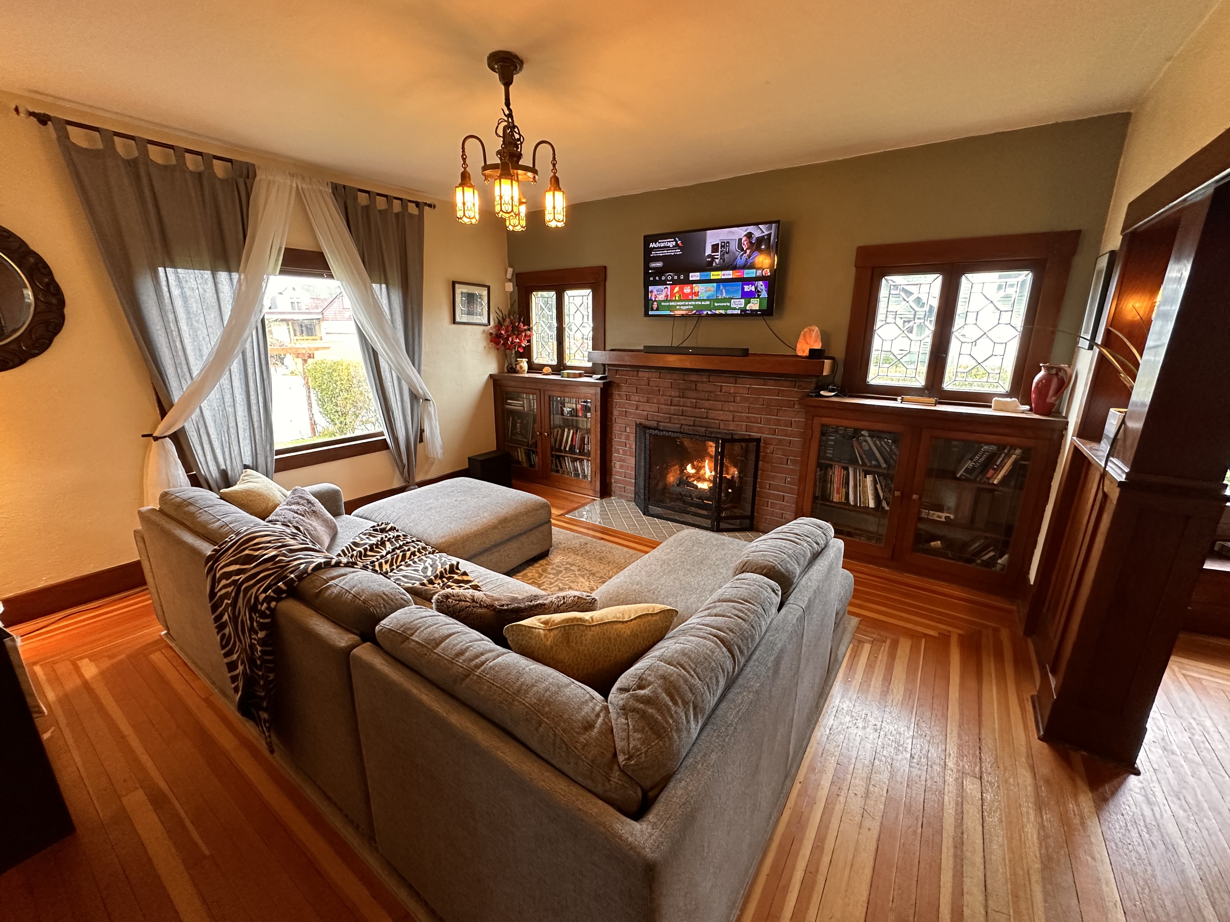 The Edison historic living room with fireplace and original wood details.
