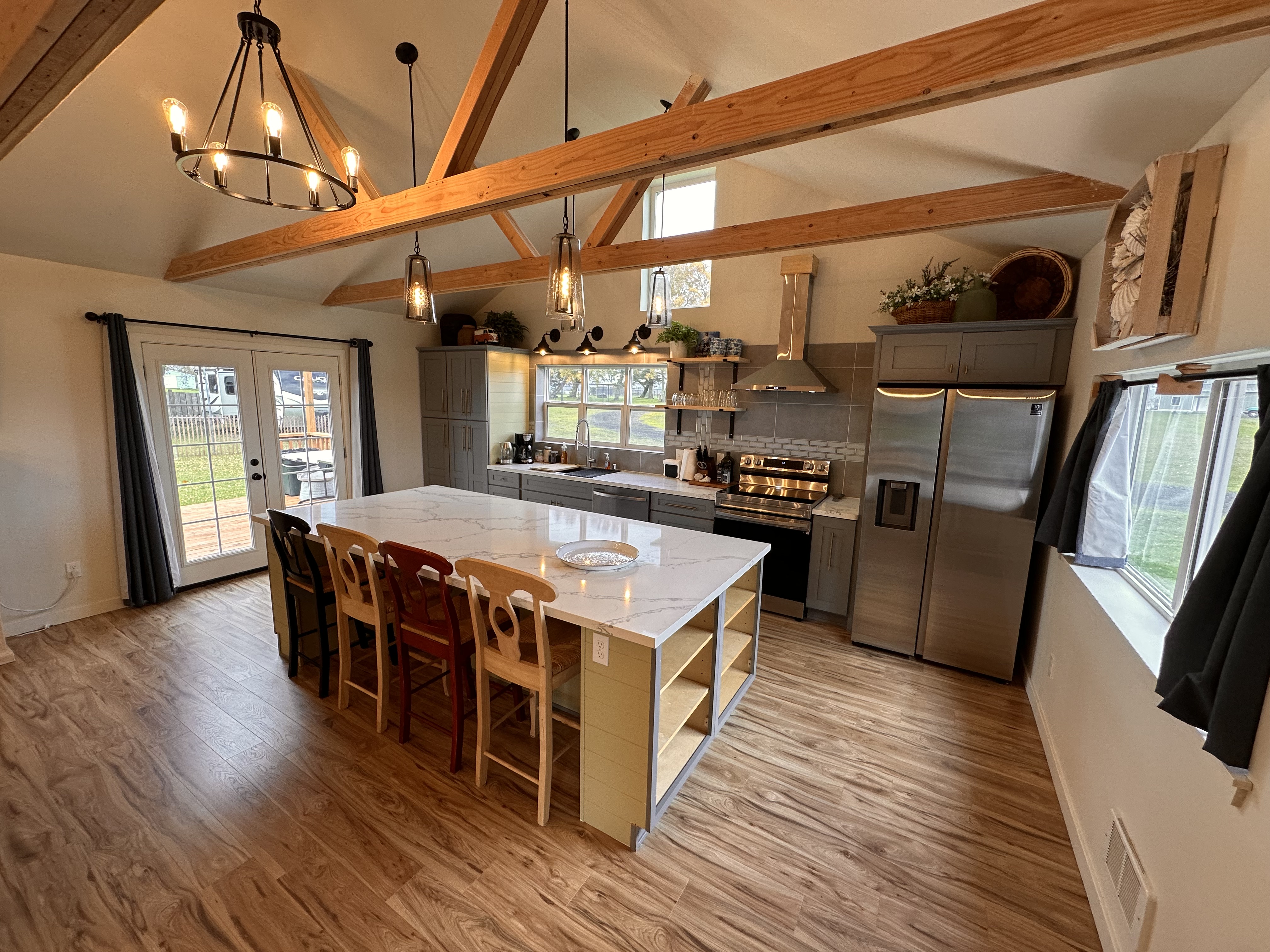 The Willapa open kitchen and gathering space with exposed wood beams.